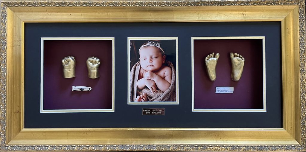 Close-up of tiny baby hand impression in frame