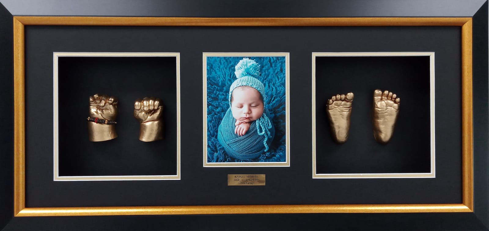 Baby hand and foot casting displayed with certificate
