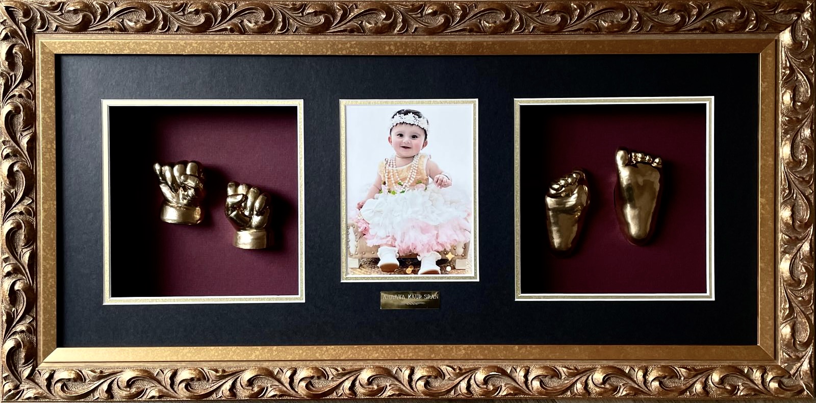 Gold-painted baby hand impression close-up